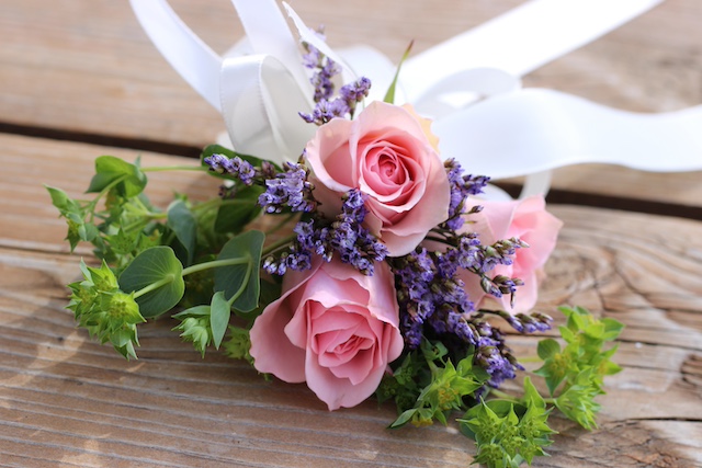 corsage with roses and small purple flowers